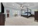 Spacious bedroom with a four-poster bed, carpet, and neutral blue walls at 270 Kemp Rd, Mooresville, NC 28117