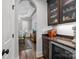 Butler's pantry with custom cabinetry, granite countertops, and an archway to the dining room at 270 Kemp Rd, Mooresville, NC 28117