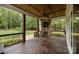 Inviting covered deck featuring stone fireplace and wood ceiling with fan at 270 Kemp Rd, Mooresville, NC 28117