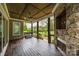 Cozy deck with wood ceiling, stone fireplace, and view of the backyard at 270 Kemp Rd, Mooresville, NC 28117