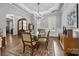 Elegant dining room featuring a glass table, chandelier, and archway entryway at 270 Kemp Rd, Mooresville, NC 28117