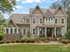 Charming two-story home showcasing a stone foundation, manicured lawn, and inviting front porch at 270 Kemp Rd, Mooresville, NC 28117