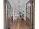 Grand foyer featuring hardwood floors, elegant lighting, and stunning wood-framed glass doors at 270 Kemp Rd, Mooresville, NC 28117