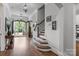 Open foyer with hardwood floors, staircase, and views to the exterior at 270 Kemp Rd, Mooresville, NC 28117