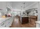 Gourmet kitchen featuring a gas cooktop, granite countertops, and open layout to the dining room at 270 Kemp Rd, Mooresville, NC 28117
