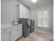 Well-equipped laundry room with modern washer, dryer, sink, and cabinetry at 270 Kemp Rd, Mooresville, NC 28117
