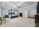 Spacious main bedroom with a canopy bed, ceiling fan, and an en-suite bathroom at 270 Kemp Rd, Mooresville, NC 28117