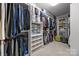 Organized walk-in closet with ample shelving, hanging rods, and storage containers at 270 Kemp Rd, Mooresville, NC 28117