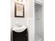 Clean bathroom featuring a sink with a dark vanity and shower with white tiled walls at 2885 Wright Ave, Salisbury, NC 28147
