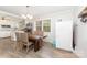 Bright dining area features stylish flooring, a modern table set, and a refrigerator near the window at 2885 Wright Ave, Salisbury, NC 28147