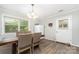 Cozy dining area features a table and chairs near a window, adjacent to a refrigerator and an exterior door at 2885 Wright Ave, Salisbury, NC 28147