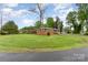 Sprawling red brick home with a manicured lawn and mature trees, showcasing classic suburban charm at 2885 Wright Ave, Salisbury, NC 28147