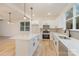 Bright kitchen features a center island, stainless steel appliances and sleek white cabinetry at 318 Sixth St, Belmont, NC 28012