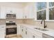 Modern kitchen with stainless steel appliances, and white countertops and cabinets at 318 Sixth St, Belmont, NC 28012