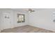 Well-lit living room with hardwood floors, a large window, and a view of the front door at 318 Sixth St, Belmont, NC 28012