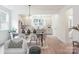 Bright, open-concept living space with modern light fixtures, hardwood flooring and adjacent kitchen at 318 Sixth St, Belmont, NC 28012