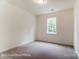 Bright bedroom with neutral carpet and natural light from large window at 3229 Bozeman Ct # 13, Stanley, NC 28164