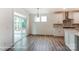 Breakfast nook with sliding glass door, wood-look floors, and bright natural light at 3229 Bozeman Ct # 13, Stanley, NC 28164