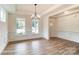 Elegant dining room with wood floors, chandelier, and large windows for natural light at 3229 Bozeman Ct # 13, Stanley, NC 28164