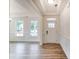 Bright foyer with beautiful molding, wood floors, and a view into the front room via expansive windows at 3229 Bozeman Ct # 13, Stanley, NC 28164