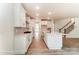 Open-concept kitchen with an island, stainless appliances, and a view to the staircase and main living area at 3229 Bozeman Ct # 13, Stanley, NC 28164