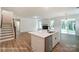 Spacious kitchen island overlooks the living room with fireplace, wood floors and backyard access at 3229 Bozeman Ct # 13, Stanley, NC 28164