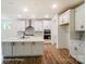 Modern kitchen with a large island, stainless steel appliances, and sleek white cabinets at 3229 Bozeman Ct # 13, Stanley, NC 28164