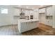Modern kitchen with an island, stainless steel appliances, and custom backsplash offers a stylish and functional space at 3229 Bozeman Ct # 13, Stanley, NC 28164