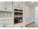 Modern kitchen features stainless steel double ovens, white cabinets, backsplash, and ample counter space at 3229 Bozeman Ct # 13, Stanley, NC 28164