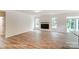 Spacious living room boasts a modern fireplace, ample natural light, and beautiful wood flooring at 3229 Bozeman Ct # 13, Stanley, NC 28164