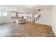 Open-concept living space features an island kitchen with stainless appliances and a staircase to the upper level at 3229 Bozeman Ct # 13, Stanley, NC 28164