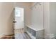 Bright mudroom features wood-look floors, a built-in bench, coat hooks, and cubbies for organization near the doorway at 3229 Bozeman Ct # 13, Stanley, NC 28164