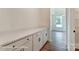 Convenient butler's pantry features shaker cabinets, quartz counters, black hardware, and wood-look flooring at 3229 Bozeman Ct # 13, Stanley, NC 28164