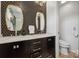 Modern bathroom featuring double sinks with gold framed mirrors and bold hexagon backsplash at 324 Elm St, Belmont, NC 28012