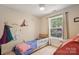 Cozy bedroom featuring playful wall decor, a small bed, and soft natural light from the window at 324 Elm St, Belmont, NC 28012
