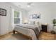 Bright bedroom featuring neutral decor, a comfortable bed, and natural light from the large window at 324 Elm St, Belmont, NC 28012