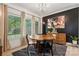 The dining room features a round wood table, modern art, and large windows at 324 Elm St, Belmont, NC 28012