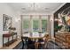 The dining room features a round wood table, modern art, and large windows at 324 Elm St, Belmont, NC 28012
