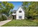 Inviting two-story home with manicured lawn, surrounded by lush green trees on a sunny day at 324 Elm St, Belmont, NC 28012