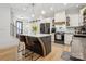 Open concept kitchen with a central island, stainless steel appliances, and stylish bar stools at 324 Elm St, Belmont, NC 28012
