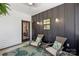 Charming outdoor patio area with stylish seating, decorative pillows and indoor/outdoor rug for relaxed entertaining at 324 Elm St, Belmont, NC 28012