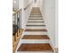 Elegant staircase with wooden steps, white risers, and a modern metal railing at 324 Elm St, Belmont, NC 28012