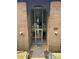 Welcoming entrance, showcasing a glass door and brick archway, inviting visitors inside at 415 Orchard Trace Ln # 1, Charlotte, NC 28213