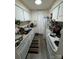 Functional kitchen featuring white cabinets, appliances, and ample countertop space, ready for culinary creations at 415 Orchard Trace Ln # 1, Charlotte, NC 28213