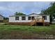 Charming single-story home featuring a cozy front porch and well-maintained lawn at 5010 Hemphill Rd, Gastonia, NC 28056