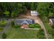 Aerial view of a home with well-maintained landscaping, a detached garage, and a sprawling lawn at 5100 Crestland Ave, Charlotte, NC 28269