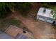 Aerial view of the home showing a large detached garage, brick patio, and spacious backyard at 5100 Crestland Ave, Charlotte, NC 28269