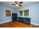 A bedroom with hardwood floors, two windows with blinds, and painted blue at 5100 Crestland Ave, Charlotte, NC 28269