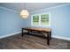 Bright dining room featuring stylish flooring, walls, and a modern light fixture at 5100 Crestland Ave, Charlotte, NC 28269