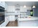 Bright kitchen featuring white cabinets, marble backsplash, stainless steel appliances, and granite counters at 5100 Crestland Ave, Charlotte, NC 28269